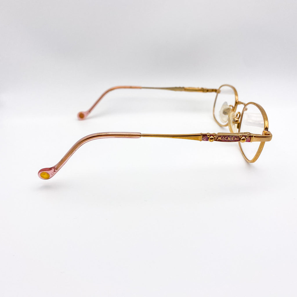 Gold-rimmed eyeglasses on a white background