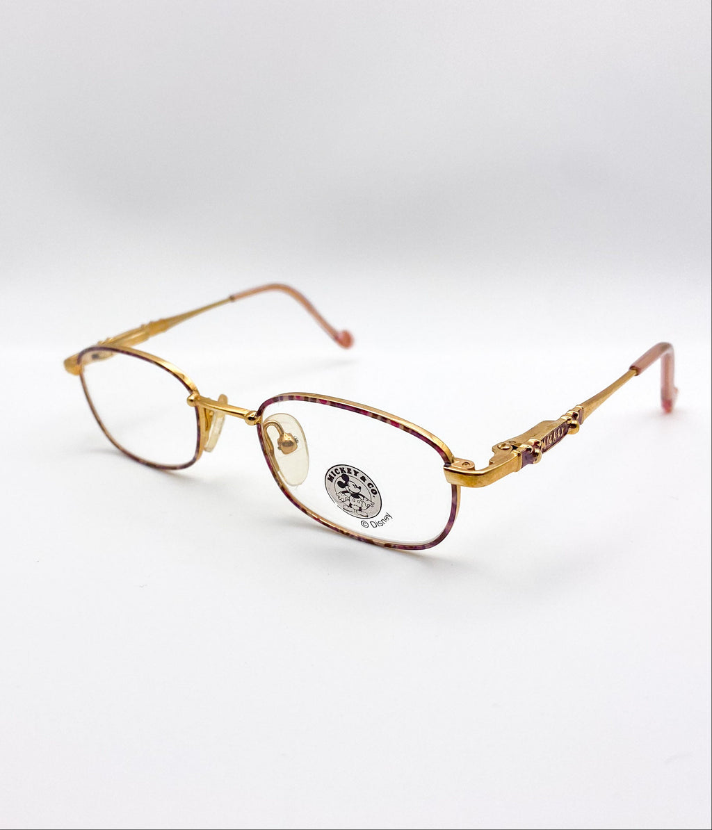 Gold-framed eyeglasses on a white background