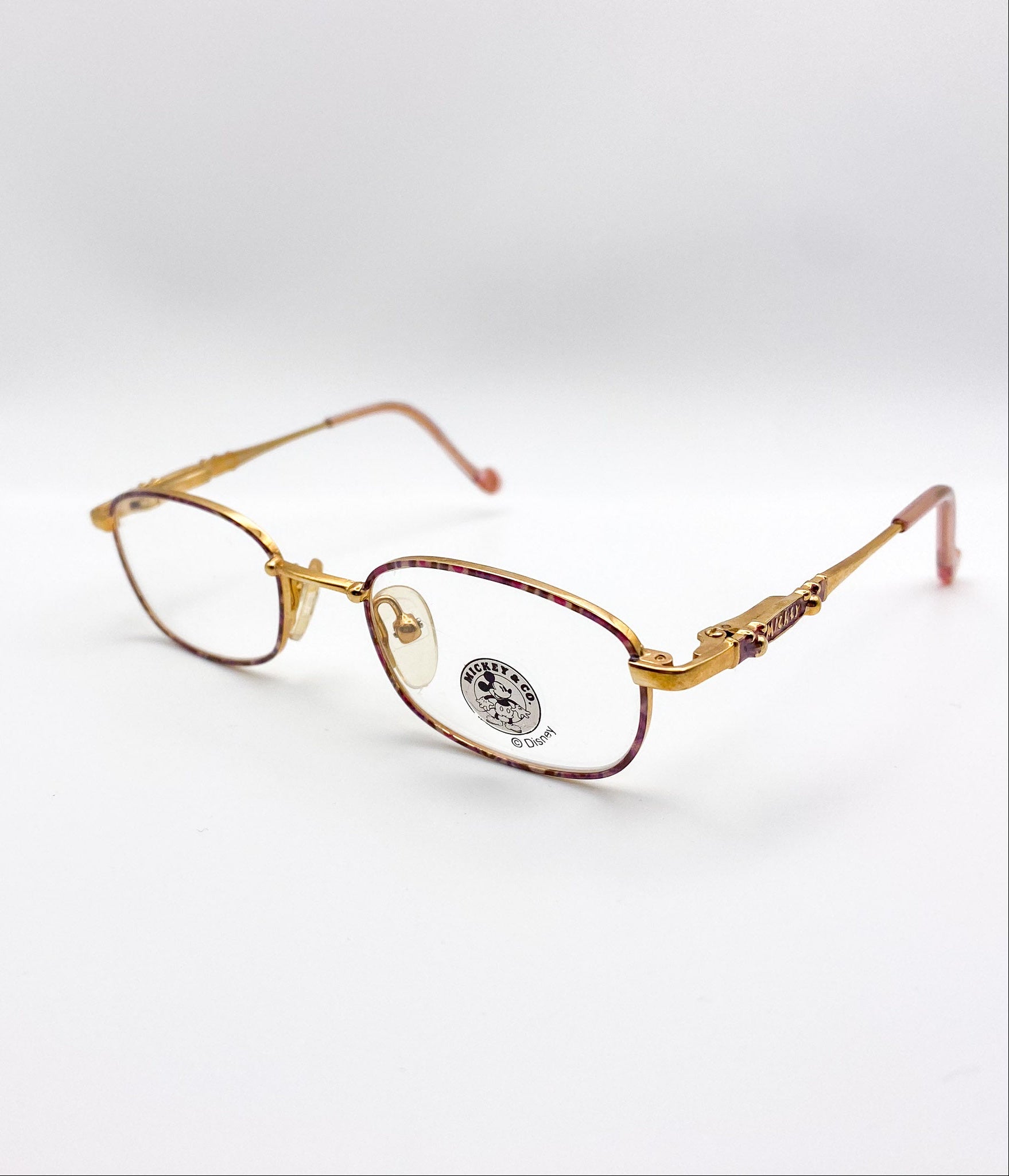 Gold-framed eyeglasses on a white background