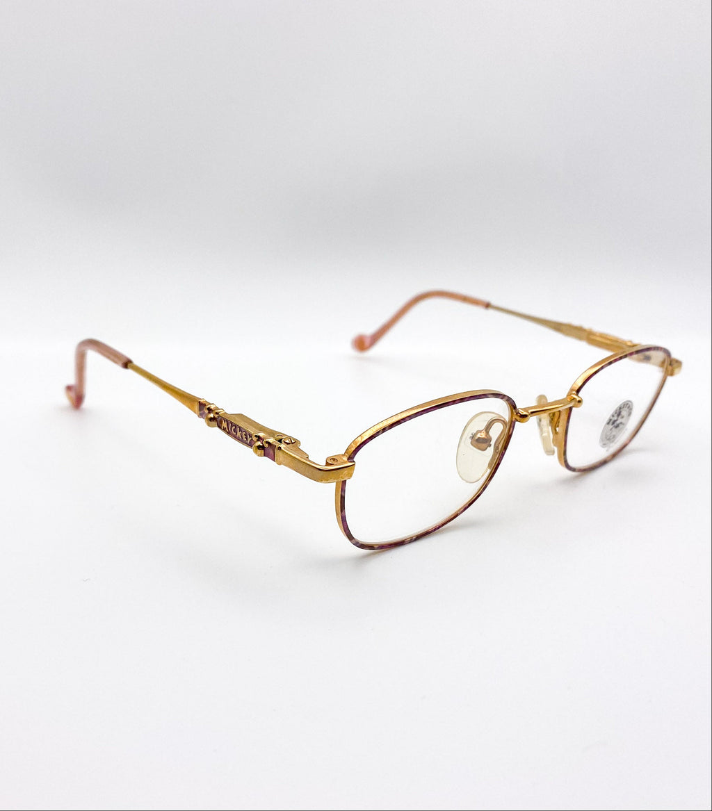 Gold-framed eyeglasses on a white background