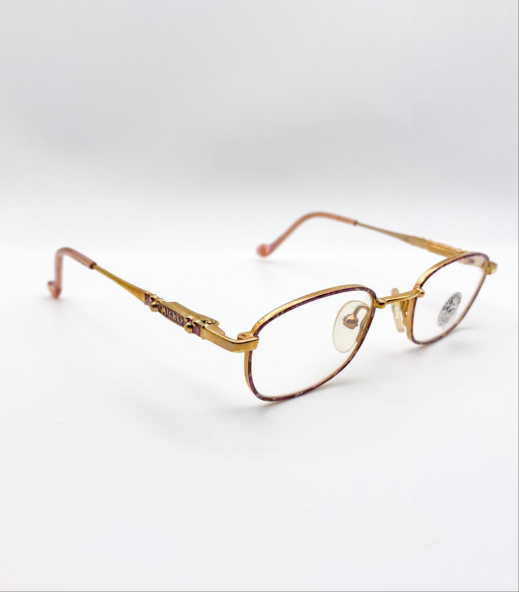 Gold-framed eyeglasses on a white background