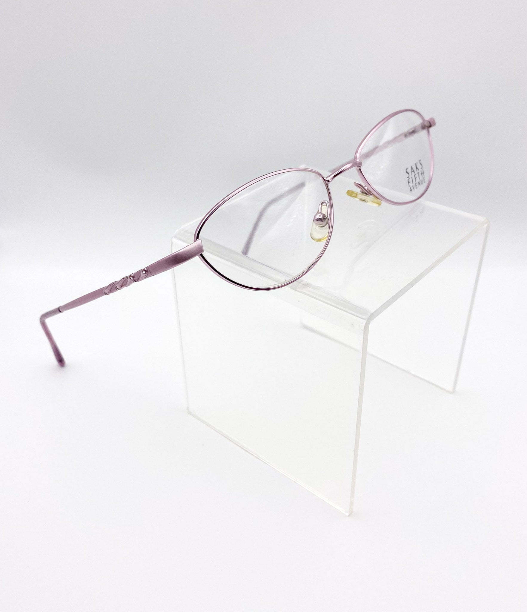 Lavender eyeglasses on a white surface