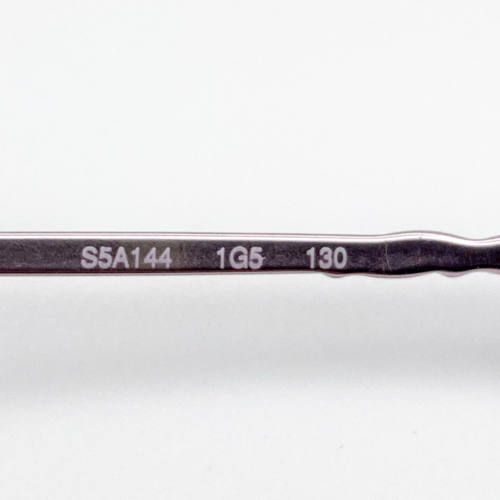 Eyeglasses temple area with engraved text on a white background