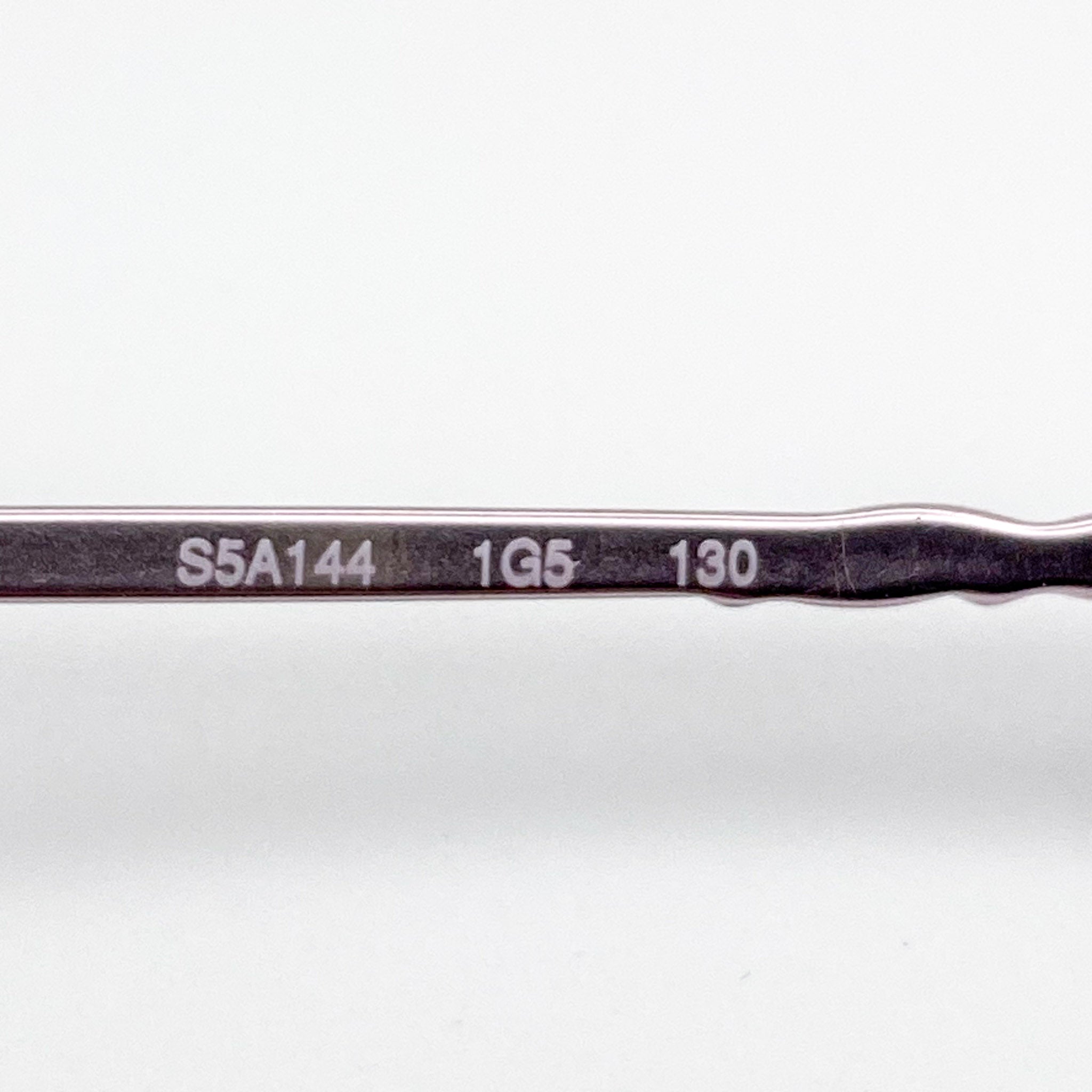 Eyeglasses temple area with engraved text on a white background