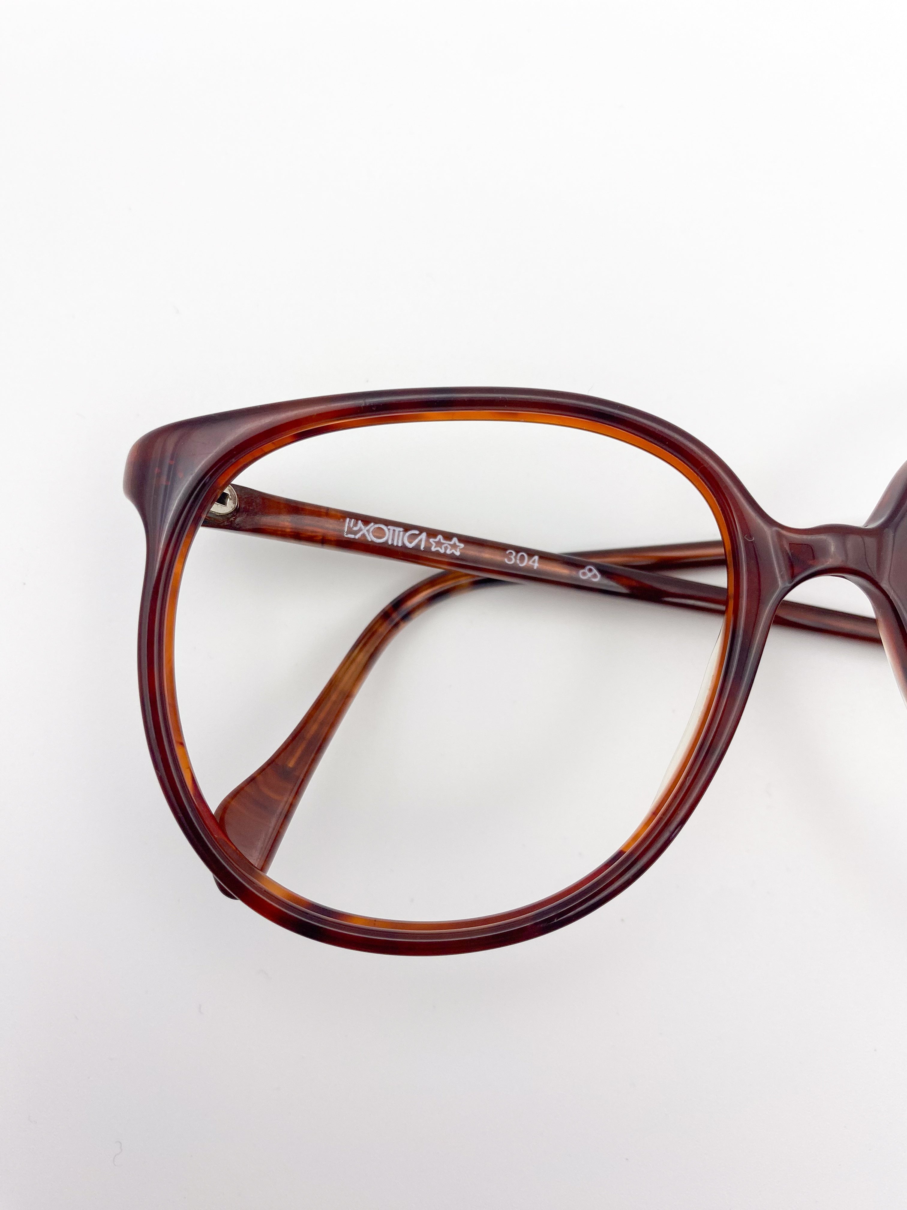 Brown tortoiseshell eyeglasses on a white background