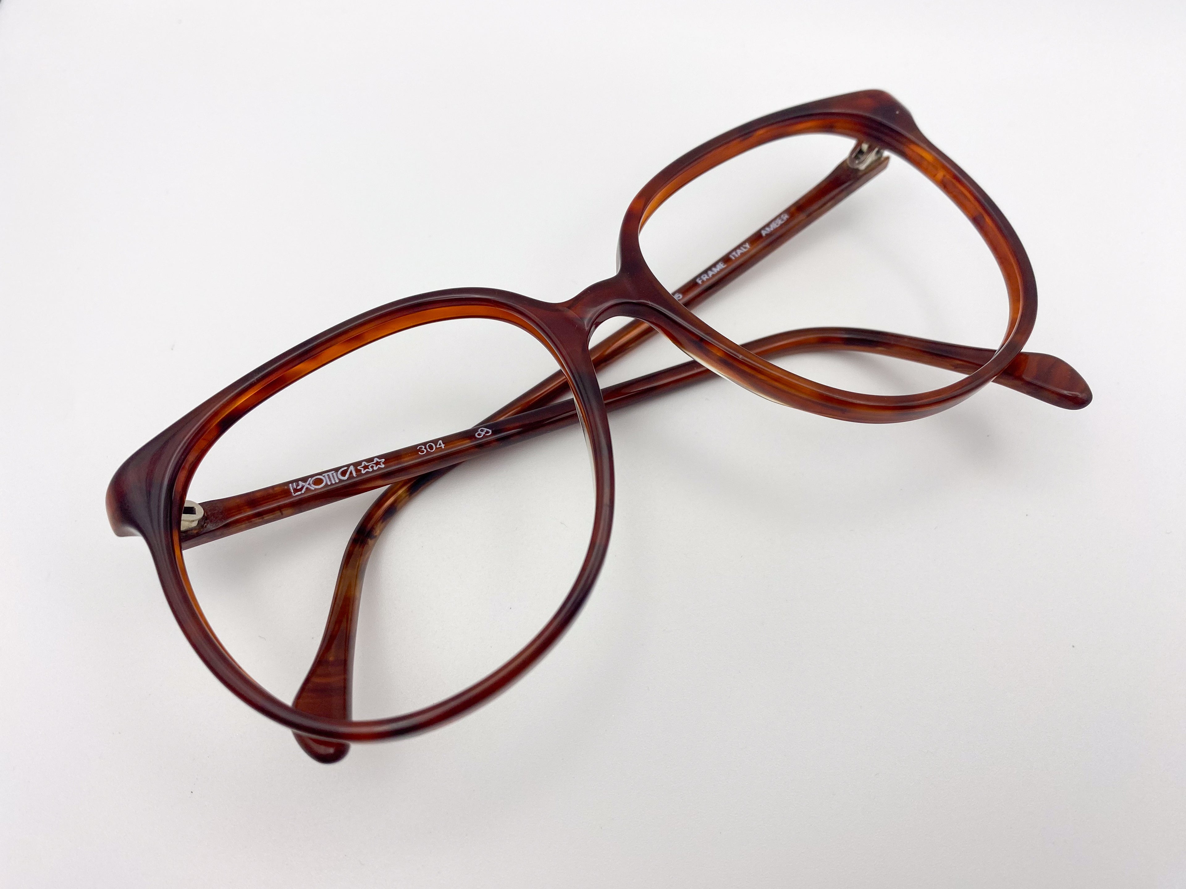 Brown Luxottica eyeglasses on a white background