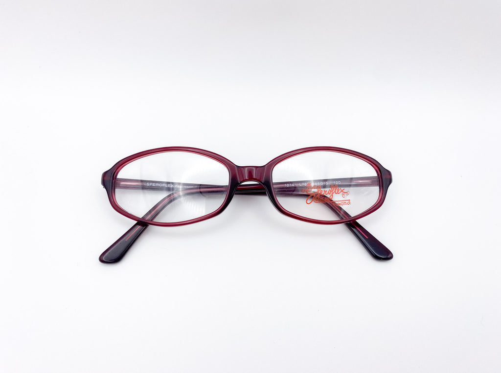 Red eyeglasses with black arms on a white background
