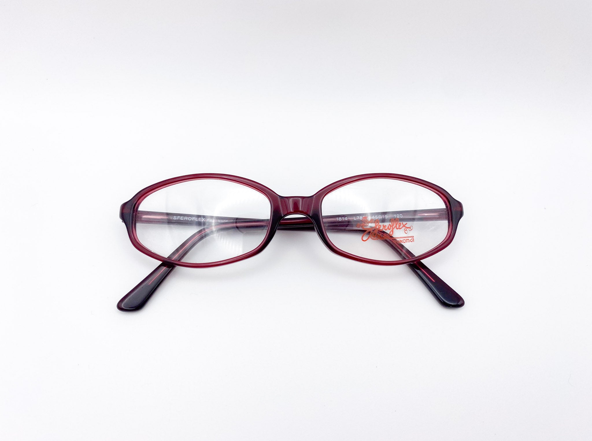 Red eyeglasses with black arms on a white background