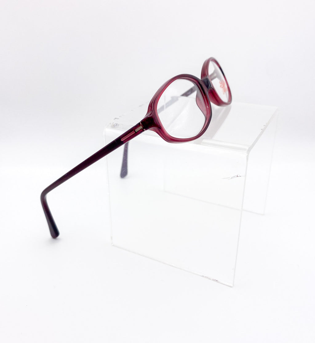 Red eyeglasses on a white background