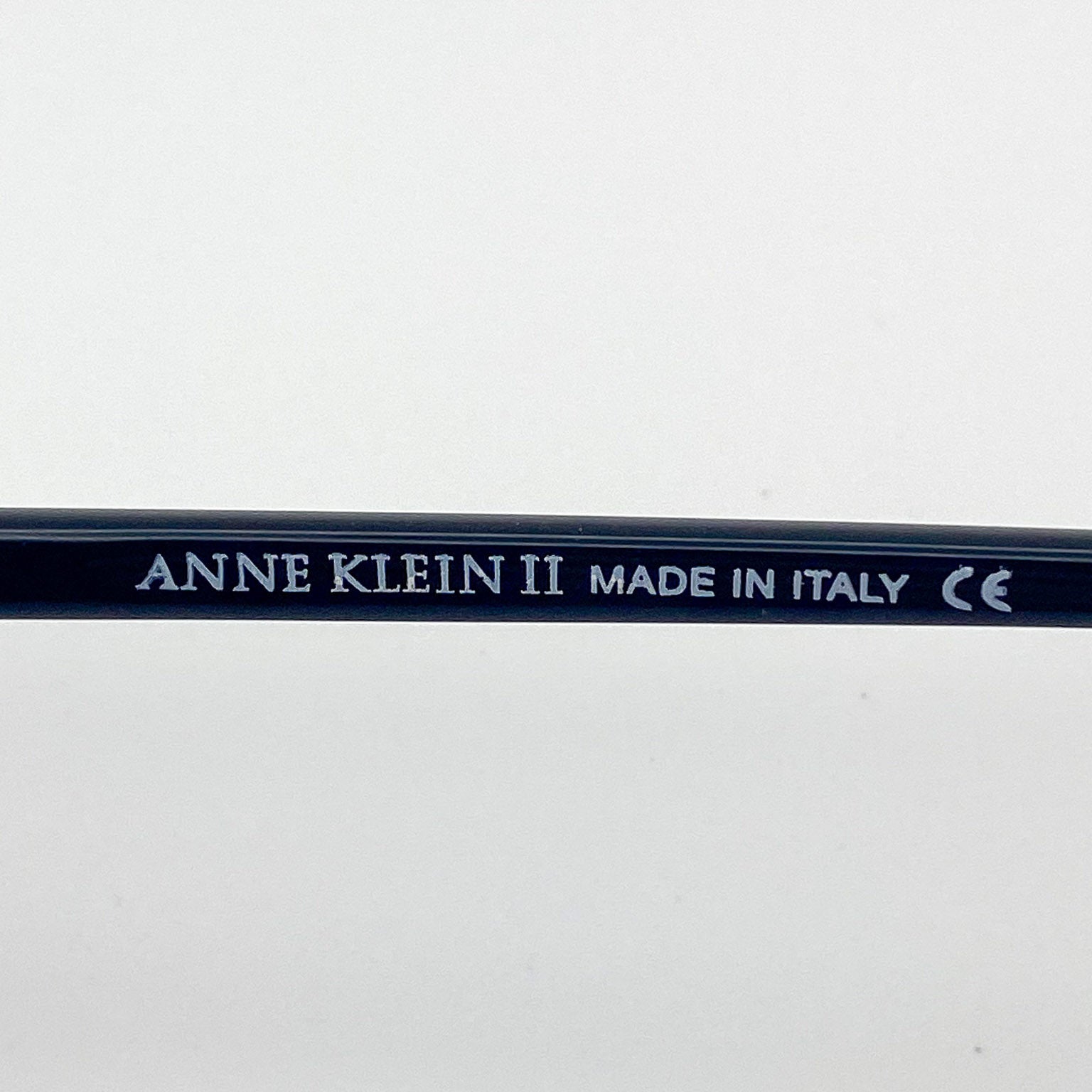 Black temple arm with 'Anne Klein II' branding on a white background