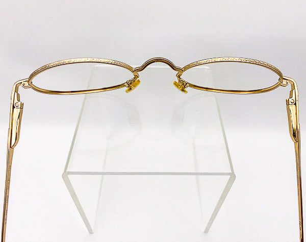Gold-framed eyeglasses on a white background