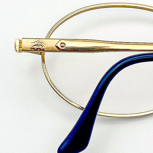 Gold eyeglasses frame on a white background