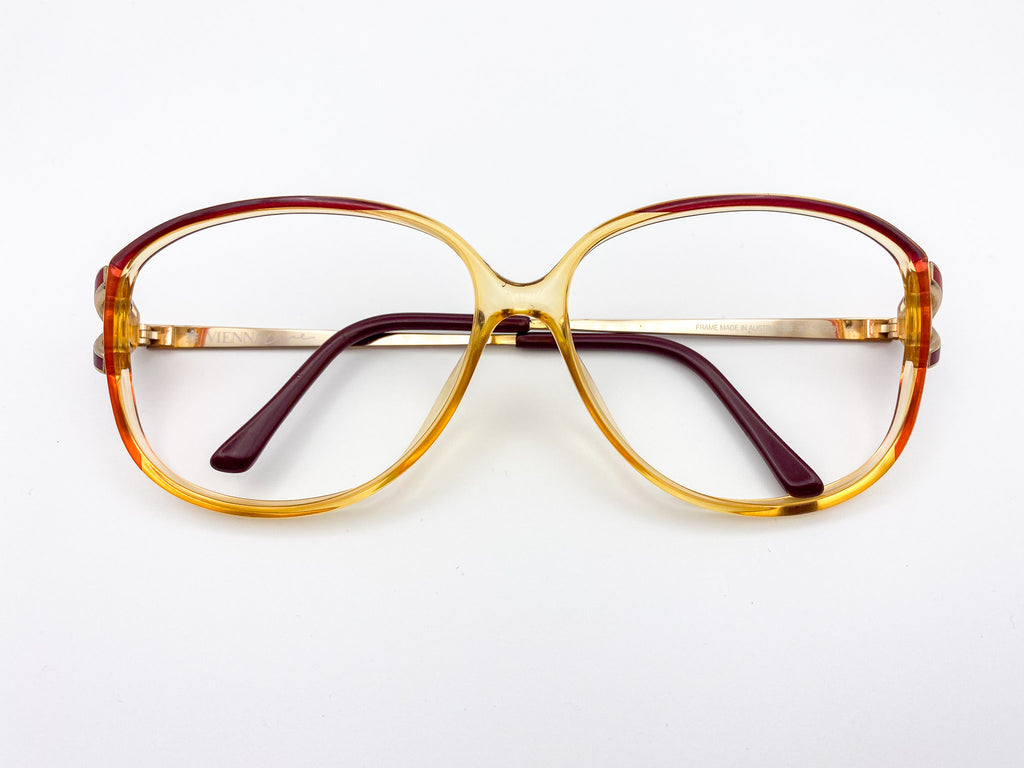 Vintage eyeglasses with a gold frame on a white background