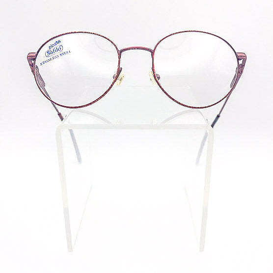 Vintage round eyeglasses with a burgundy frame on a clear stand