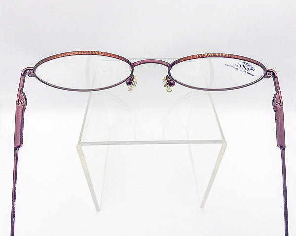 Safilo Elasta eyeglasses on a clear stand against a white background