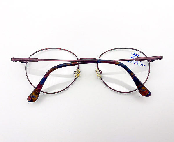 Vintage round metal eyeglasses on a white background