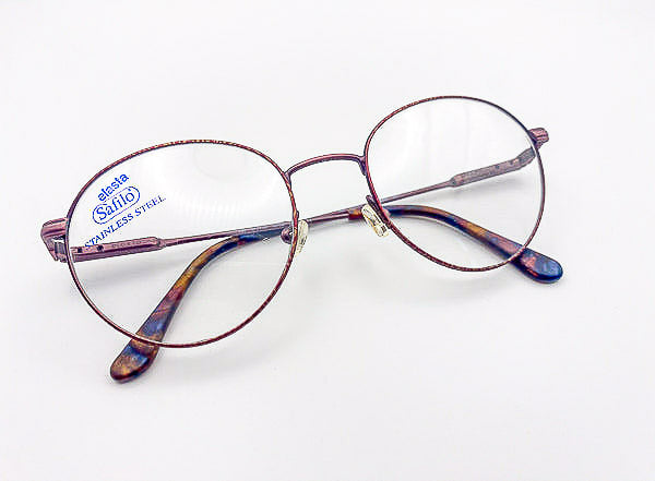 Round eyeglasses with marbled accents on a white background