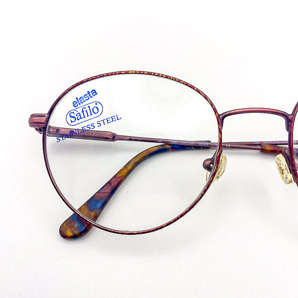 Safilo eyeglasses with 'elasta' and 'Stainless Steel' text on a white background