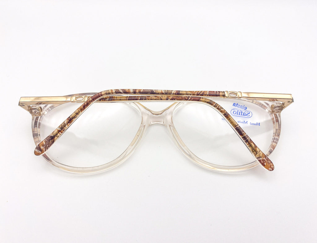 1980s clear eyeglasses with a tortoiseshell frame on a white background