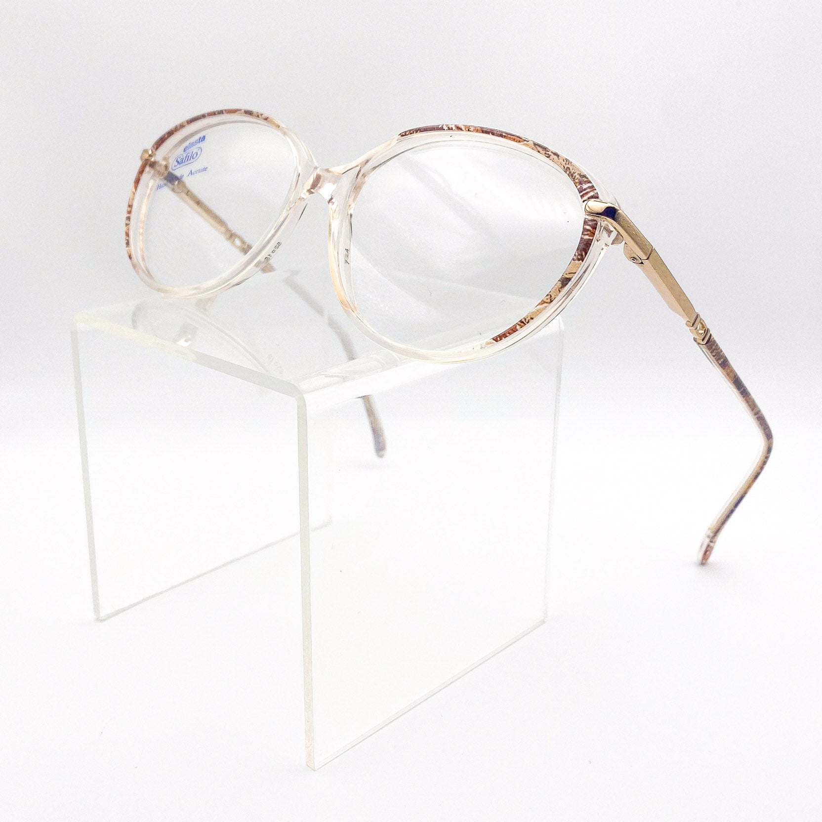 Gold-framed eyeglasses on a white background