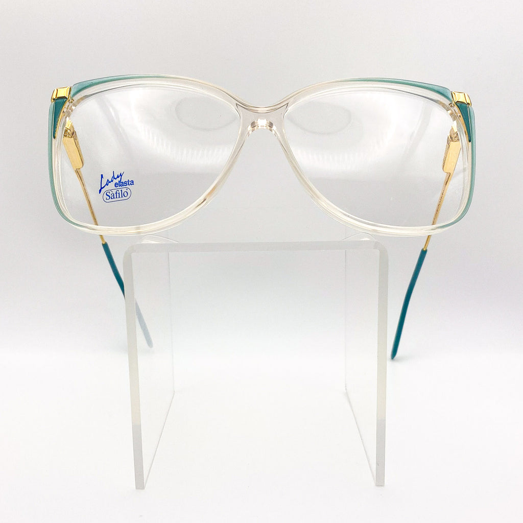 Vintage Safilo eyeglasses with gold and green frame on a white background