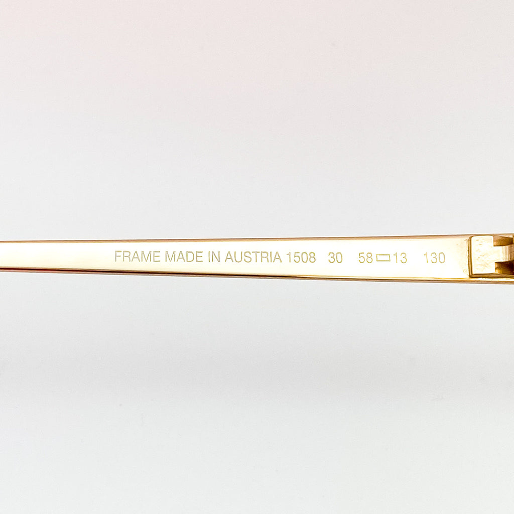 Gold frame with engraved text on a white background