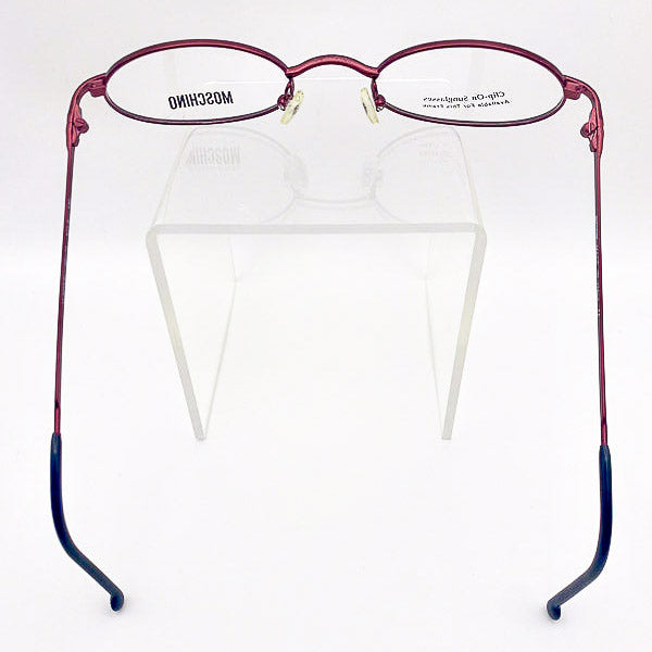 Moschino burgundy metal eyeglasses on a clear stand with a white background