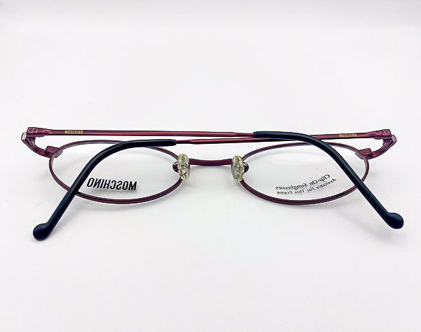 1990s eyeglasses with 'Moschino' branding on a white background