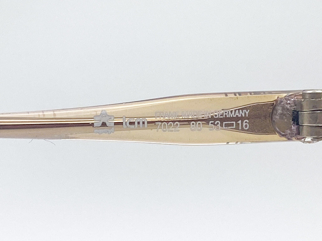 Close-up of a temple arm with  'ICM' branding on a white background