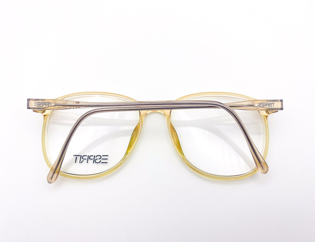1980s yellow eyeglasses with clear lenses on a white background
