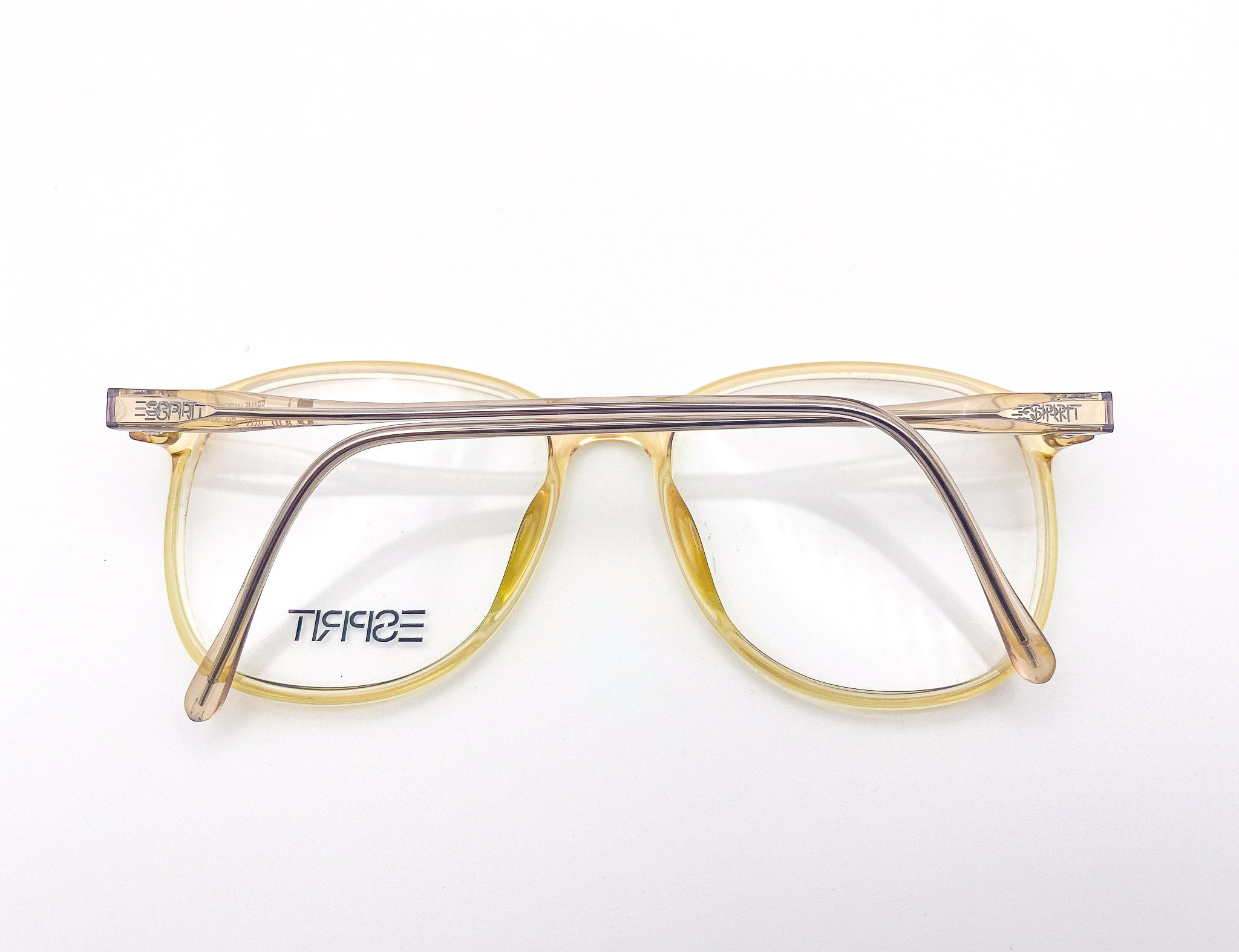 1980s yellow eyeglasses with clear lenses on a white background