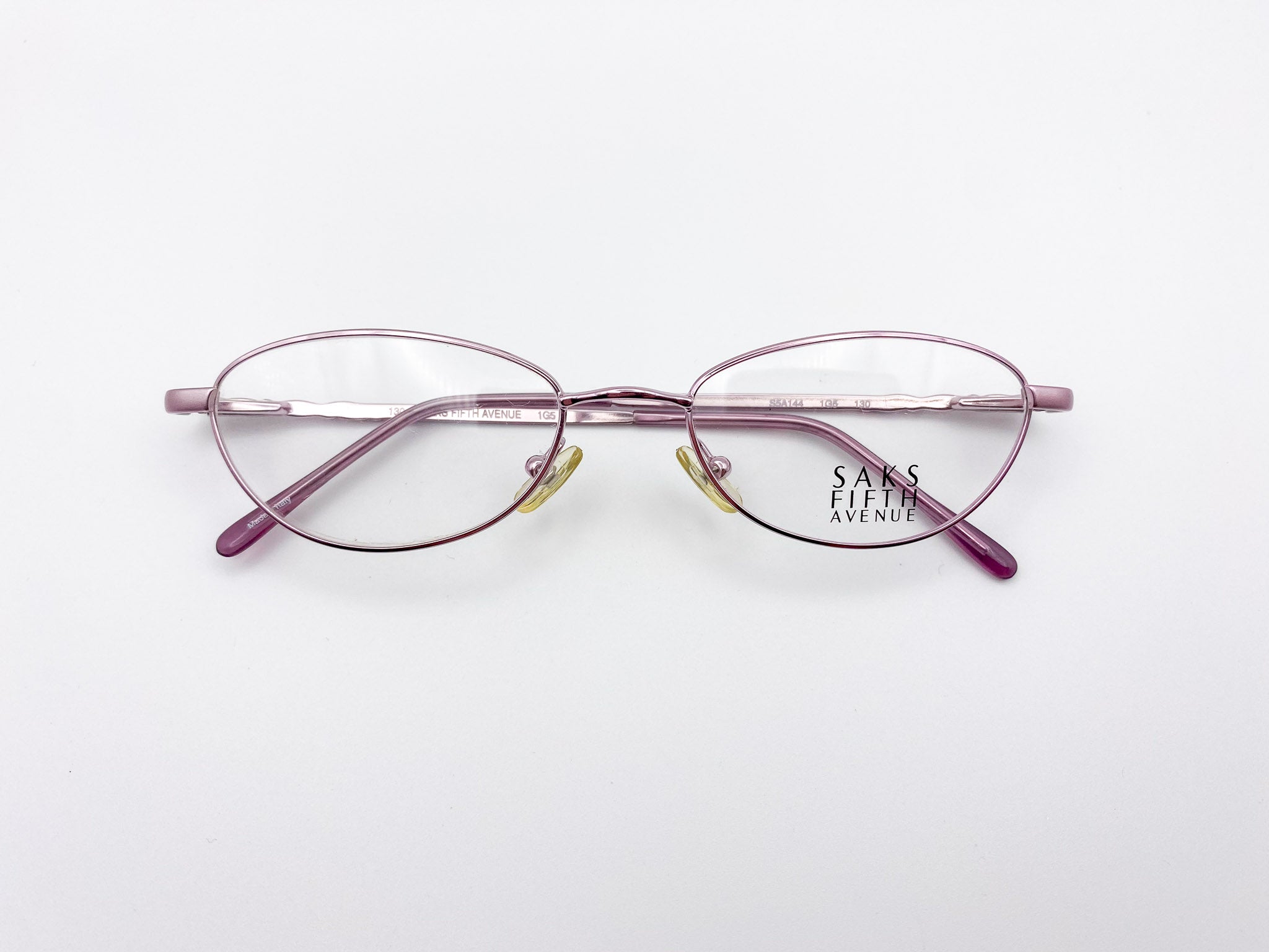 Lavender eyeglasses with 'Saks Fifth Avenue' branding on a white background