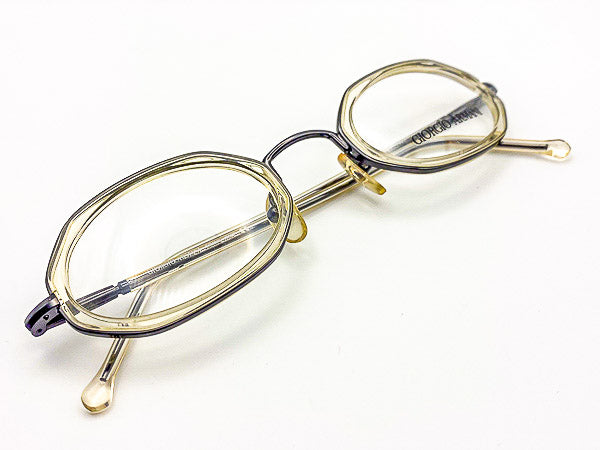 Clear grey eyeglasses with black metal accents on a white background