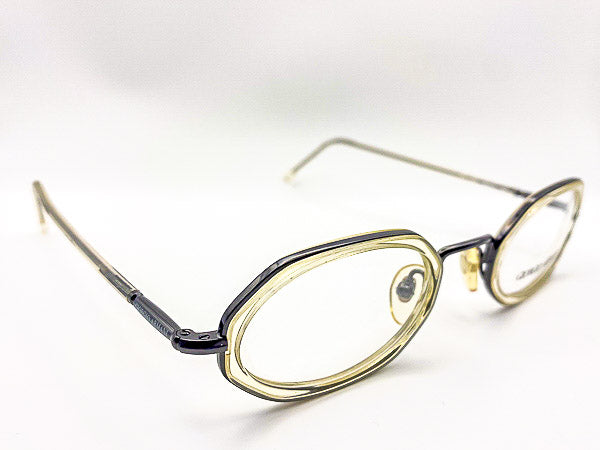 Pair of eyeglasses with translucent grey frame on a white background