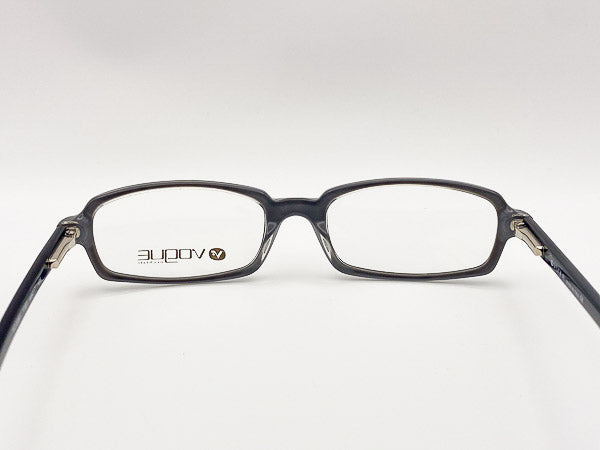 Black eyeglasses with a visible brand logo on a white background