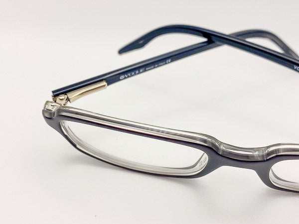 Close-up of a pair of eyeglasses with black frames on a white background