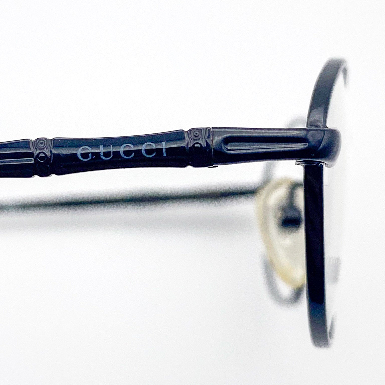 Close-up of Gucci metal eyeglasses on a white background