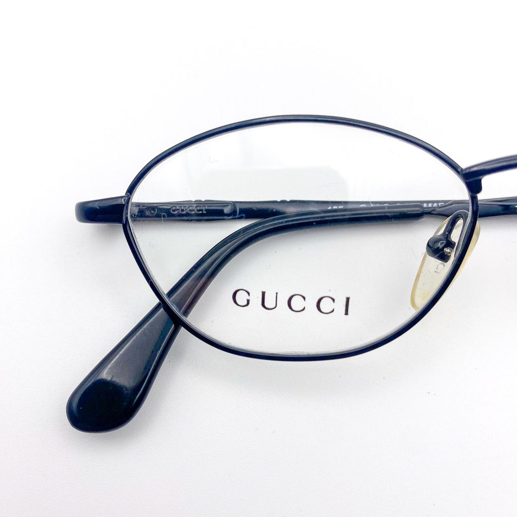 Black Gucci eyeglasses on a white background
