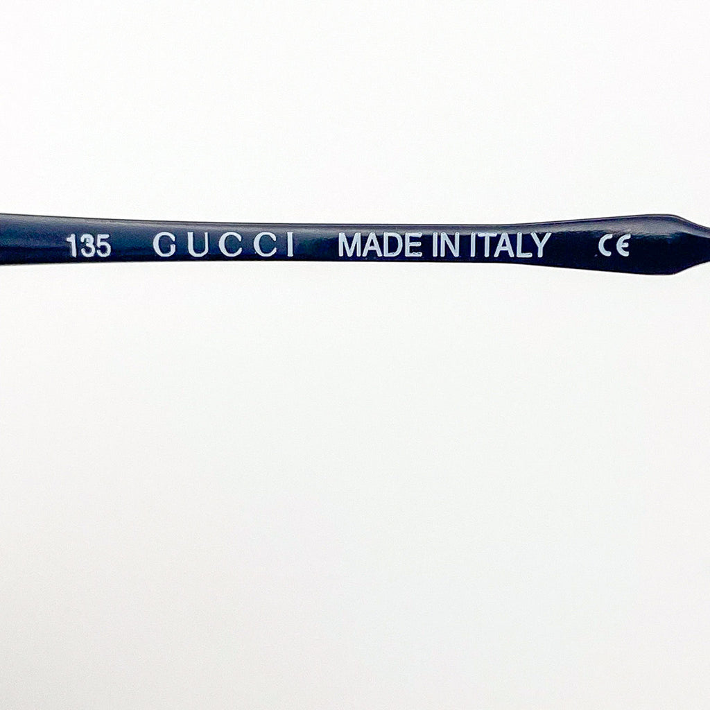 Gucci temple frame with 'Made in Italy' text on a white background