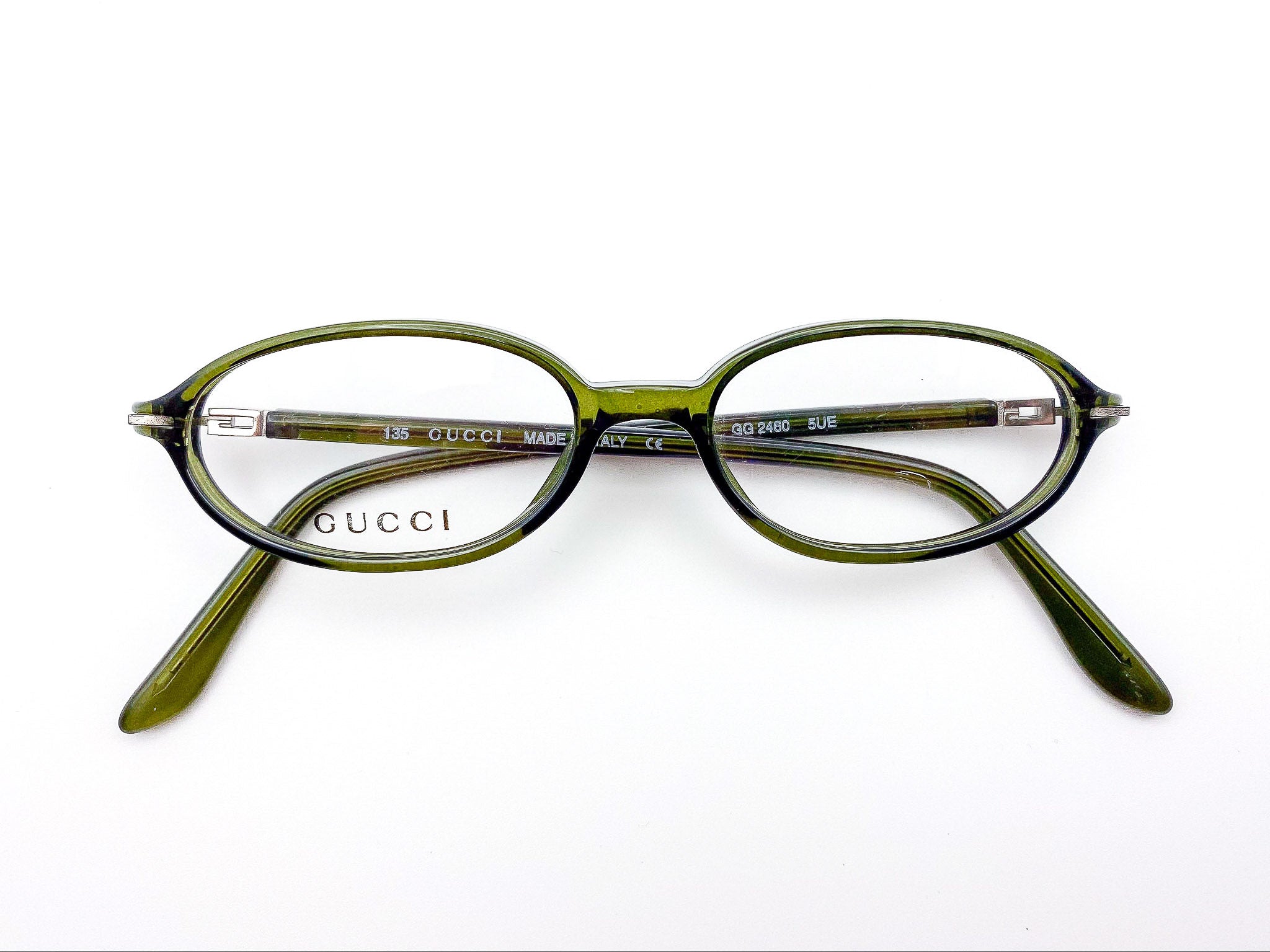 1990s vintage olive green Gucci eyeglasses on a white background