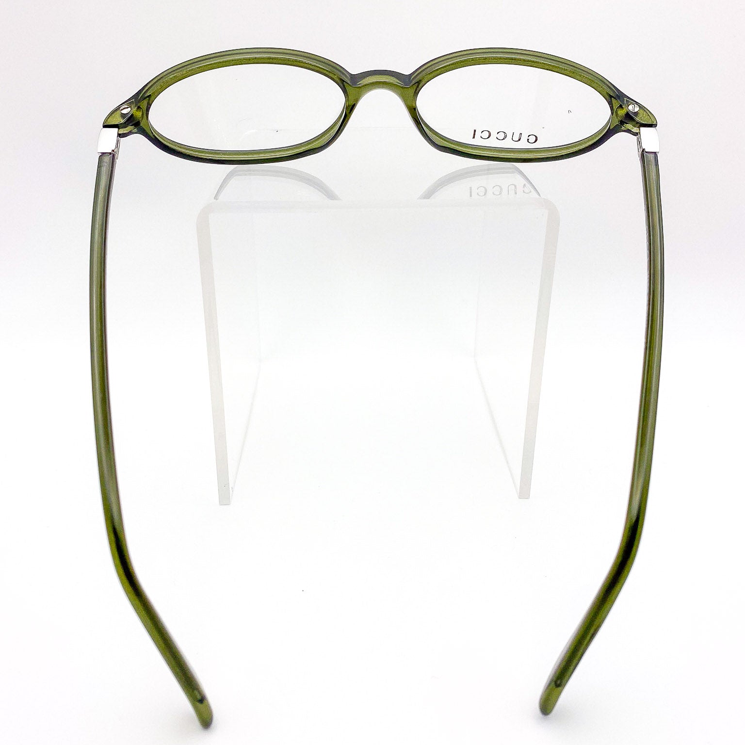Green Gucci glasses on a white background