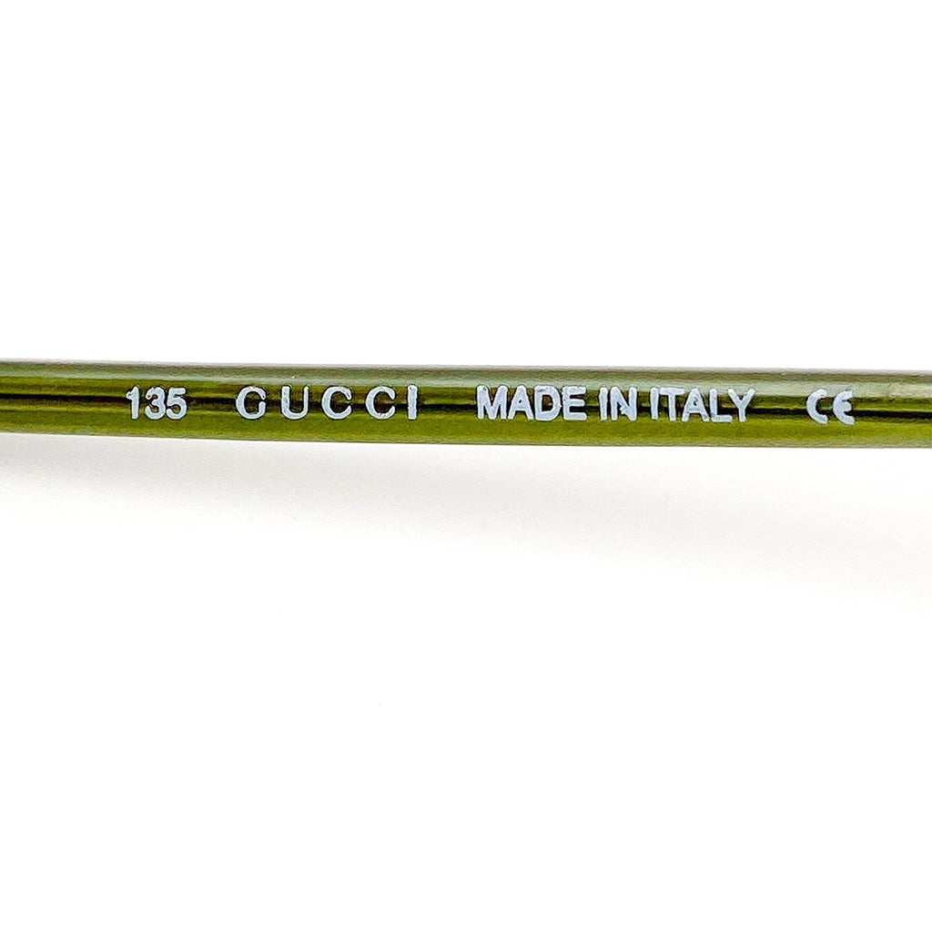 Gucci temple arm with 'Made in Italy' text on a white background