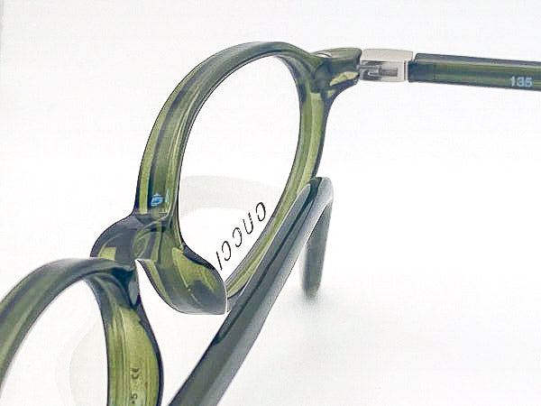 Olive green eyeglasses with a clear background