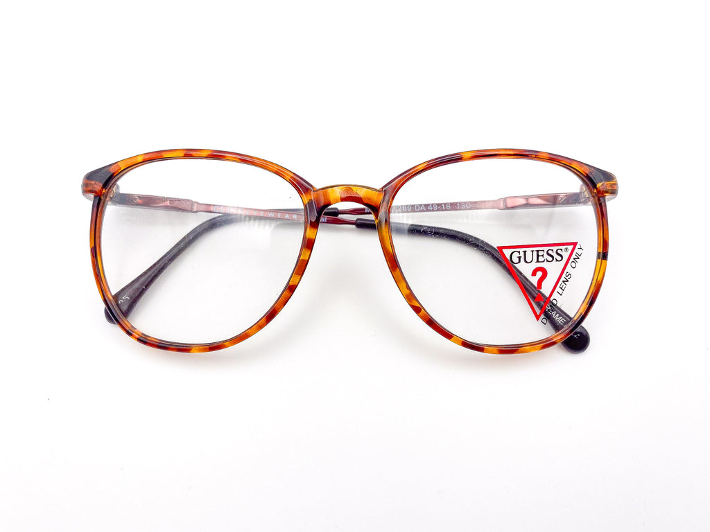 1980s tortoiseshell glasses with Guess logo on a white background