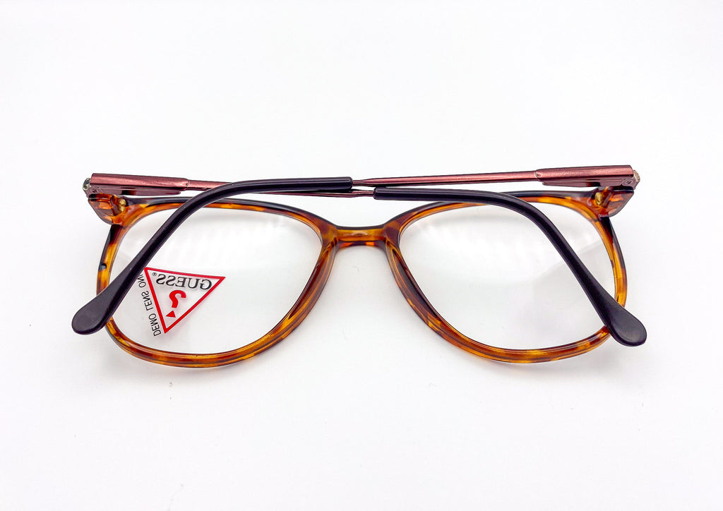 Vintage eyeglasses with a tortoiseshell frame on a white background