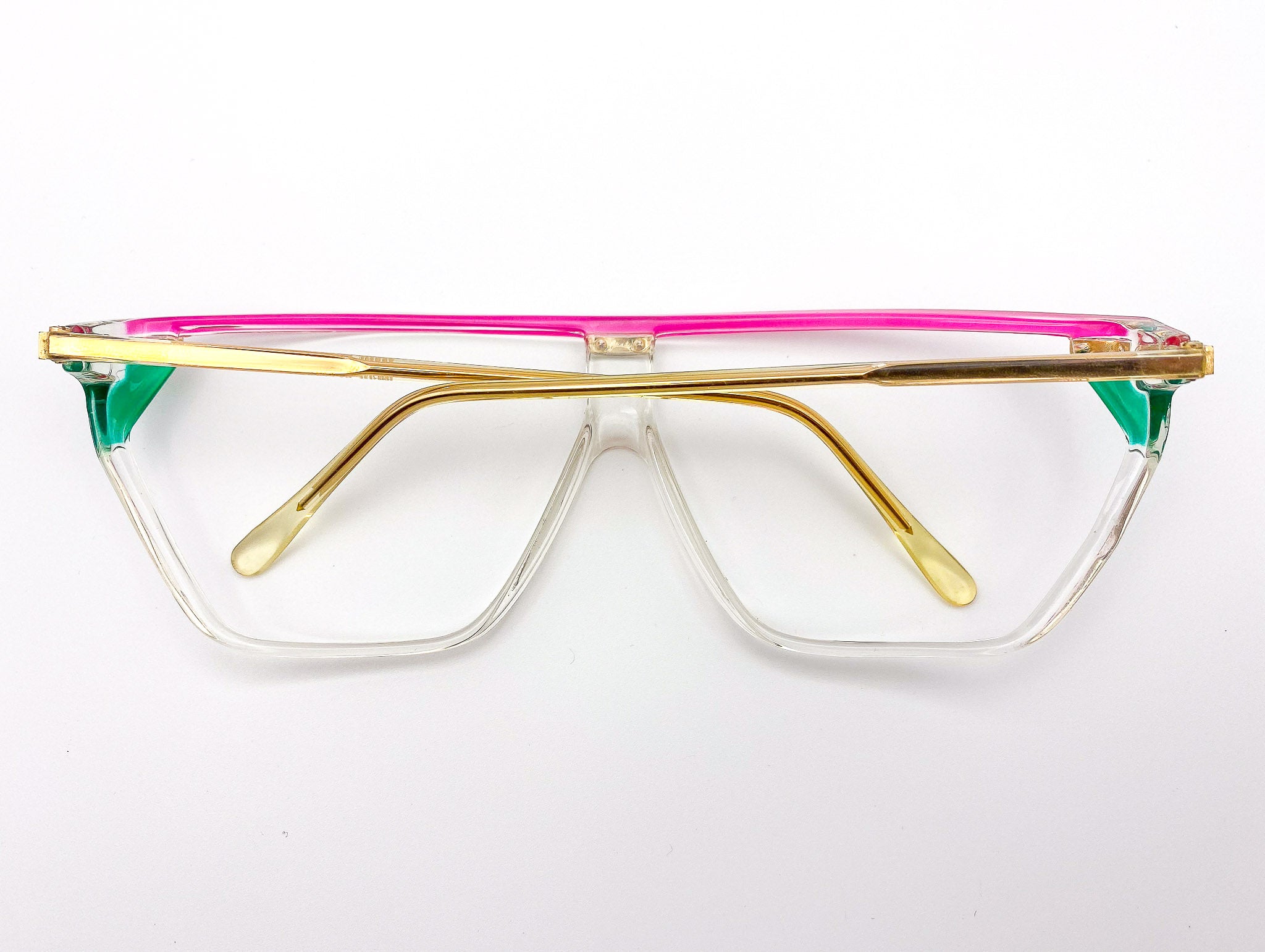 Vintage visor eyeglasses with gold frame, pink top bar, and green sides on a white background