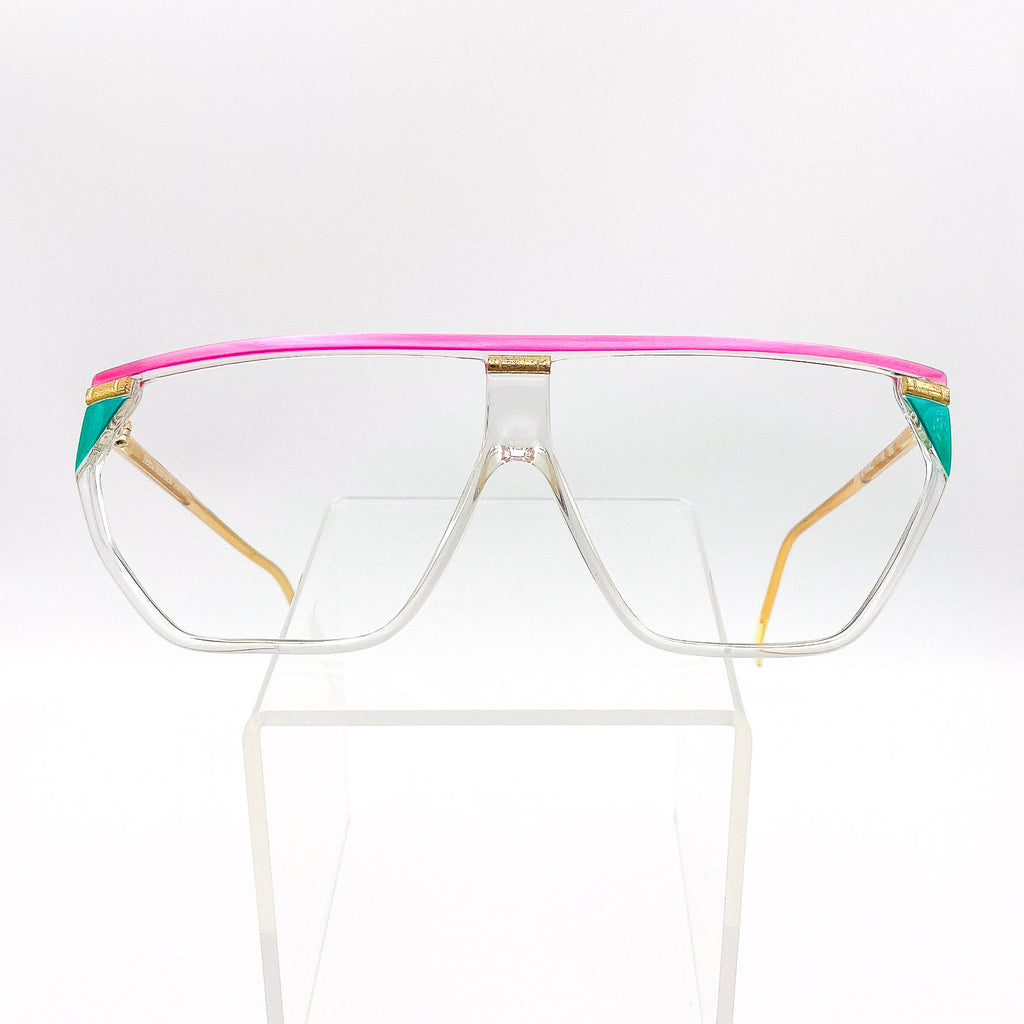 Clear glasses with a pink and green frame on a white background