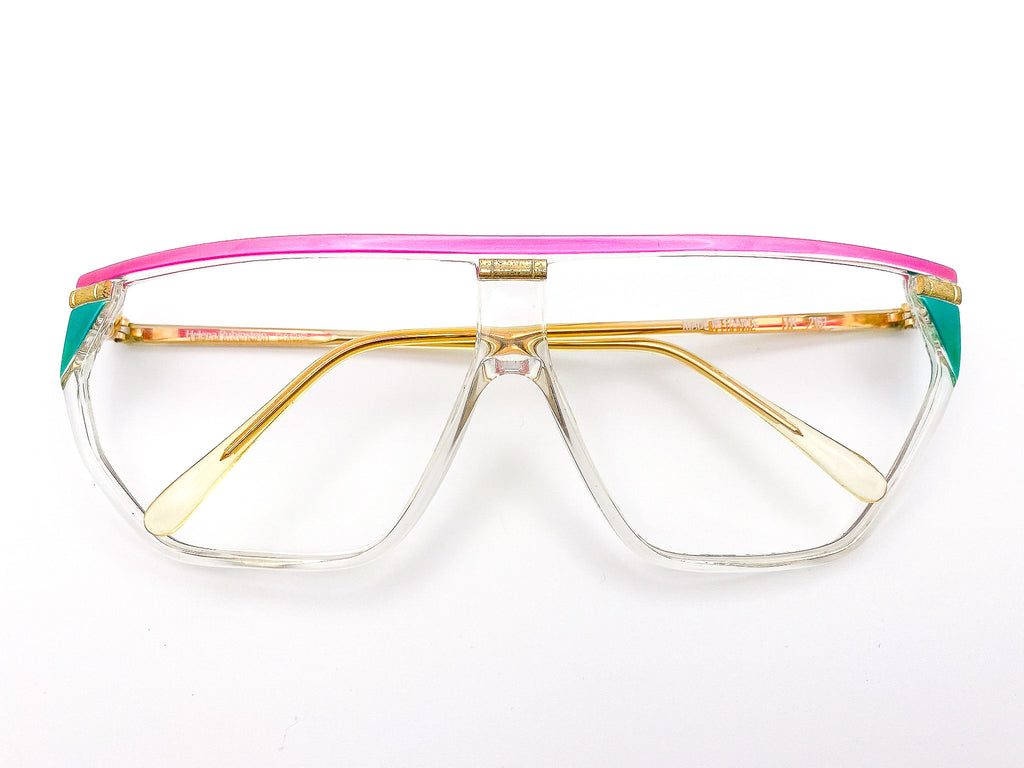 1980s Helena Rubinstein eyeglasses with a pink and gold frame on a white background