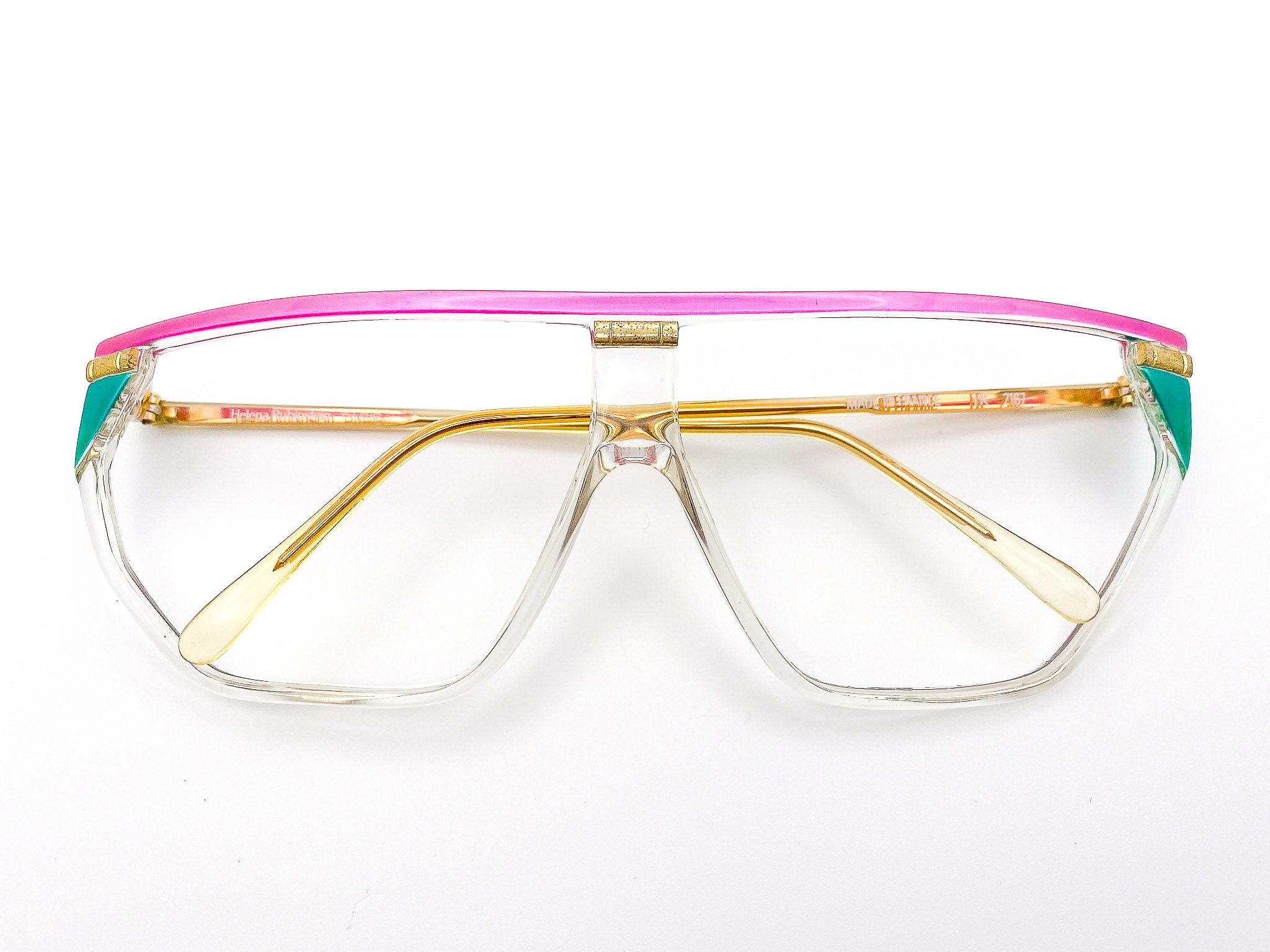 1980s Helena Rubinstein eyeglasses with a pink and gold frame on a white background