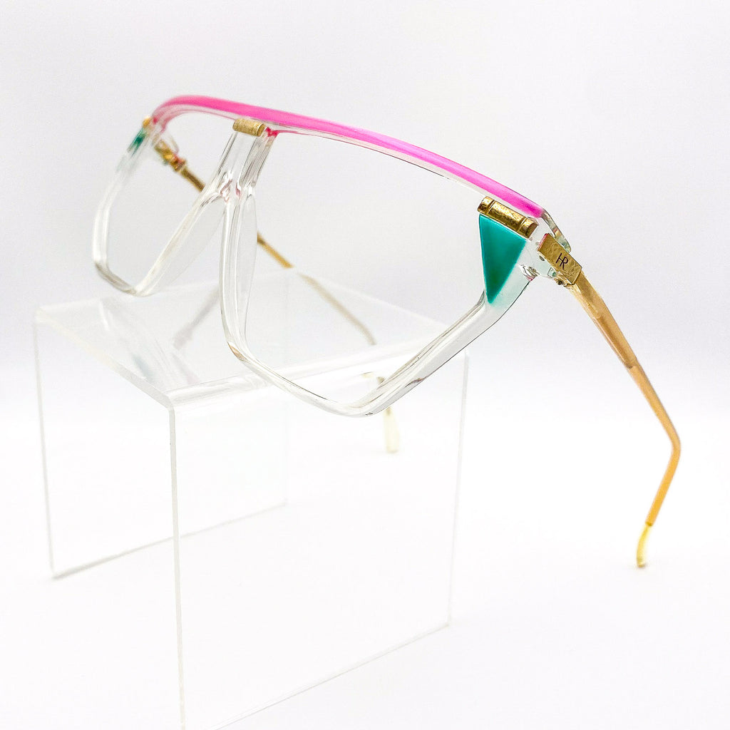 Clear sunglasses with pink and gold frames on a white background